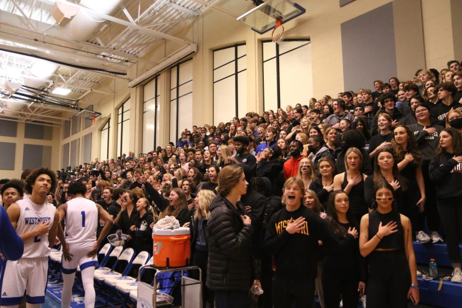The+student+section+prepares+for+the+National+Anthem+at+a+WCA+basketball+game.