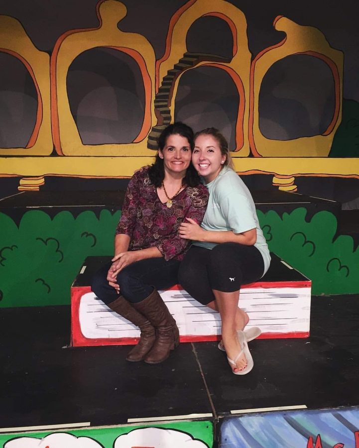 Mrs. Dianne Mueller poses with her daughter in front of her Seussical set.