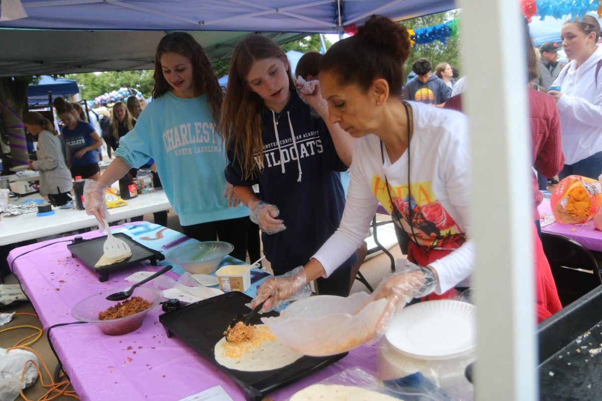 The spanish club booth bustles at the annual homecoming carnival.