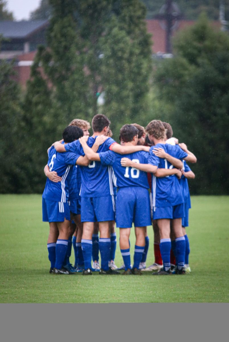 The boys huddle before kickoff