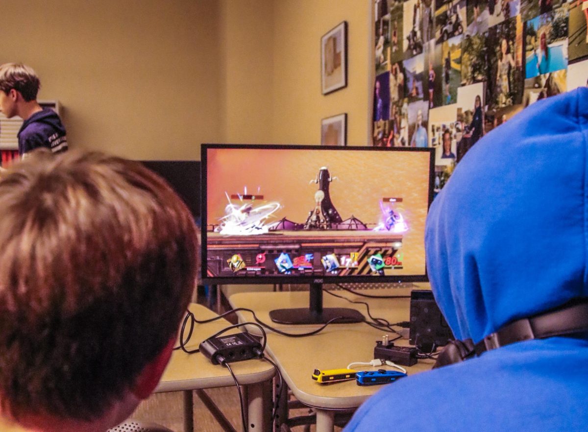 Several club members look on at the monitor.