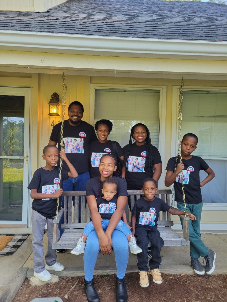 The family stand all together posing and smiling very happily. (Courtesy of Rachel Yost)