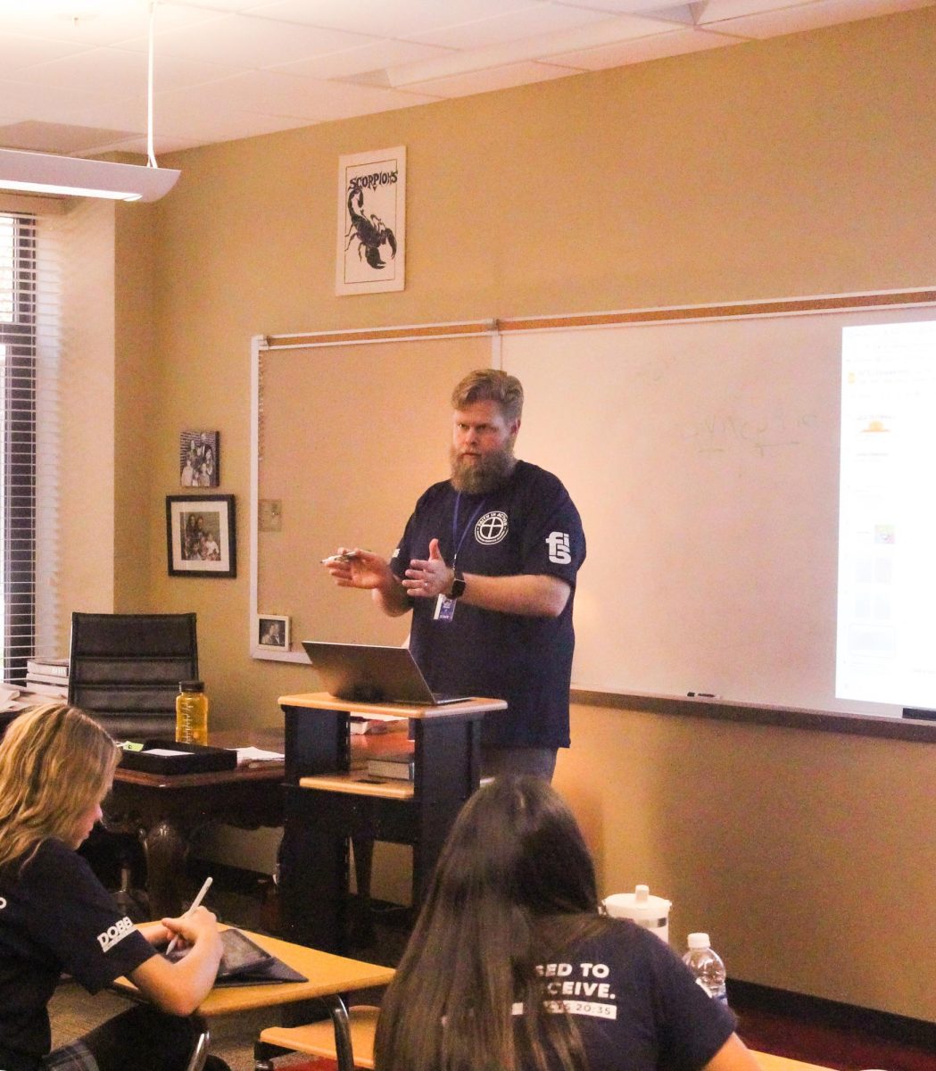 Steven Ottolini stands teaching his Freshmen New Testament class.