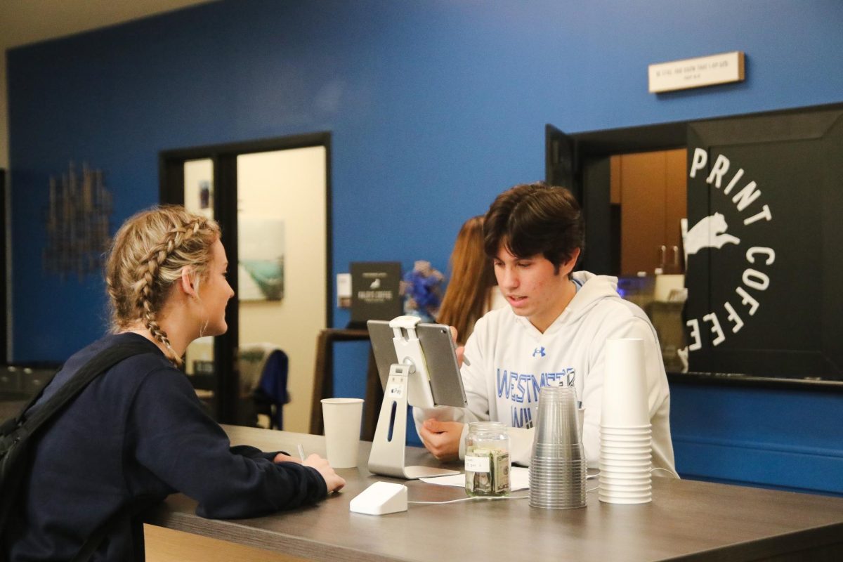 A Pawprint worker waits diligently on a customer.