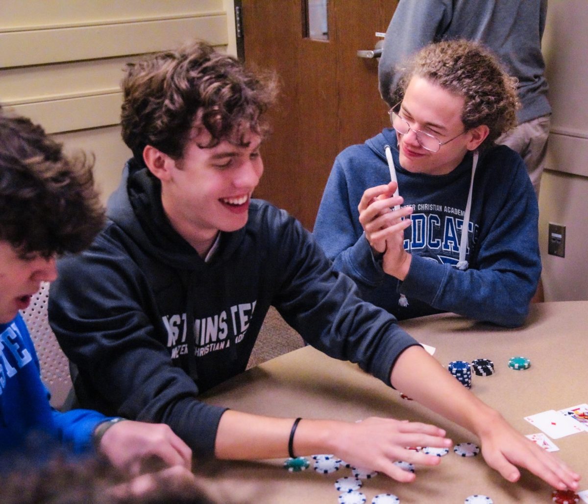 Jack Nelson congratulates Abel Tucker on winning the poker game.