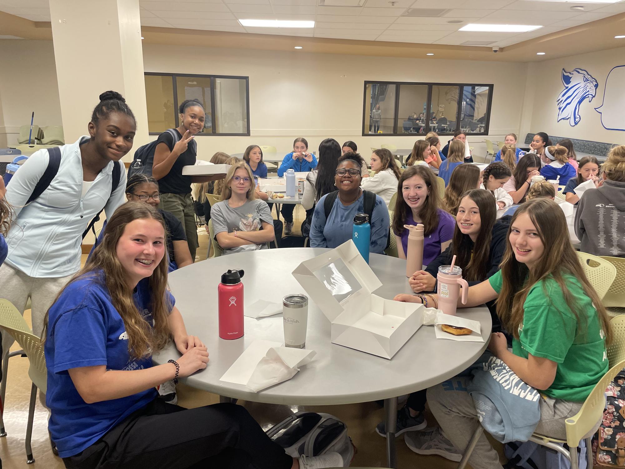 A group of PC girls sit around during a meeting.