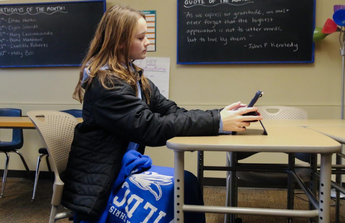 Kate Beste (Junior) in class with a coat and blanket