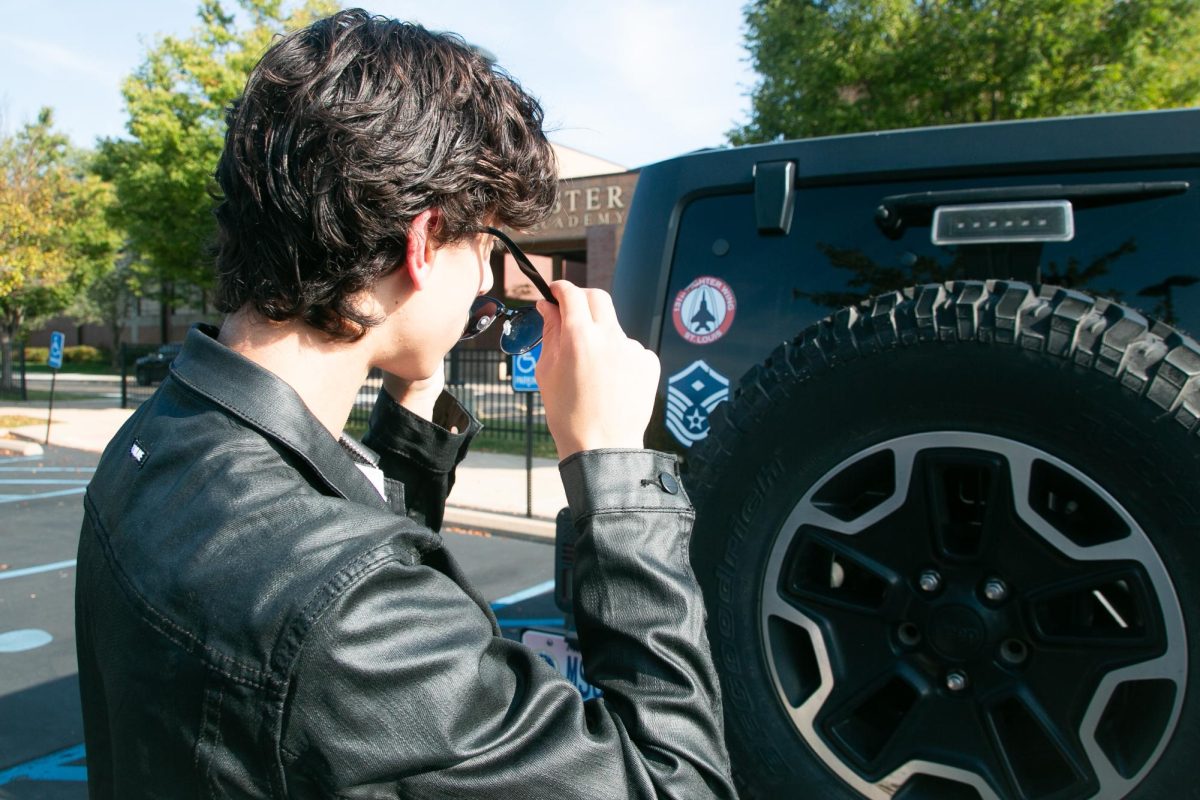 Bad Boy Stands in Front of Car and Takes Off His Sunglasses