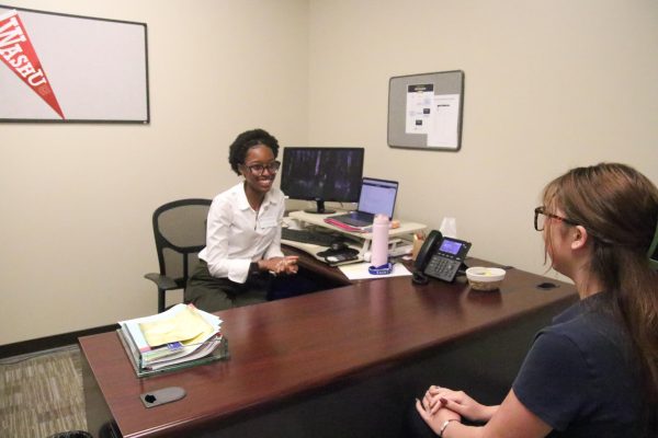 A student meeting with Mrs. Kuadio in her office