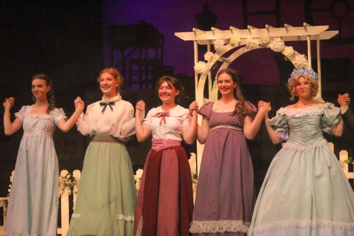 Five cast members of Little Women look towards the audience during the bows