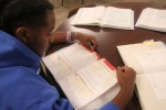 An Academically Oriented Student Pours Over a Pile of Books