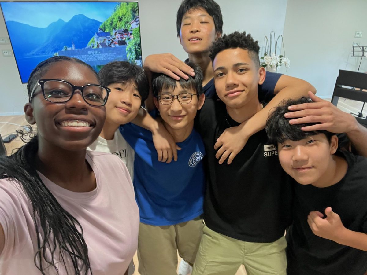 2025 Graduate Savannah Smith takes a selfie picture with multiple Japanese students in Japan.