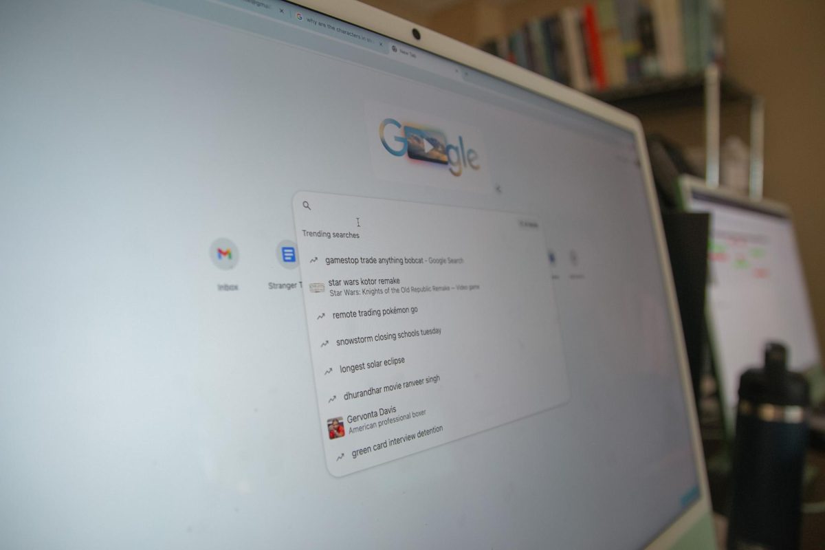 A computer on the google page search looking at the top searches of the day. 