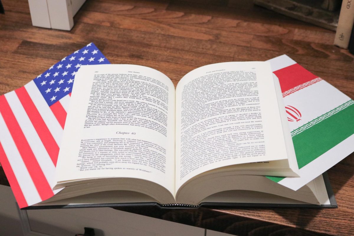 A book open with the United States and Iranian flags bordering its pages.