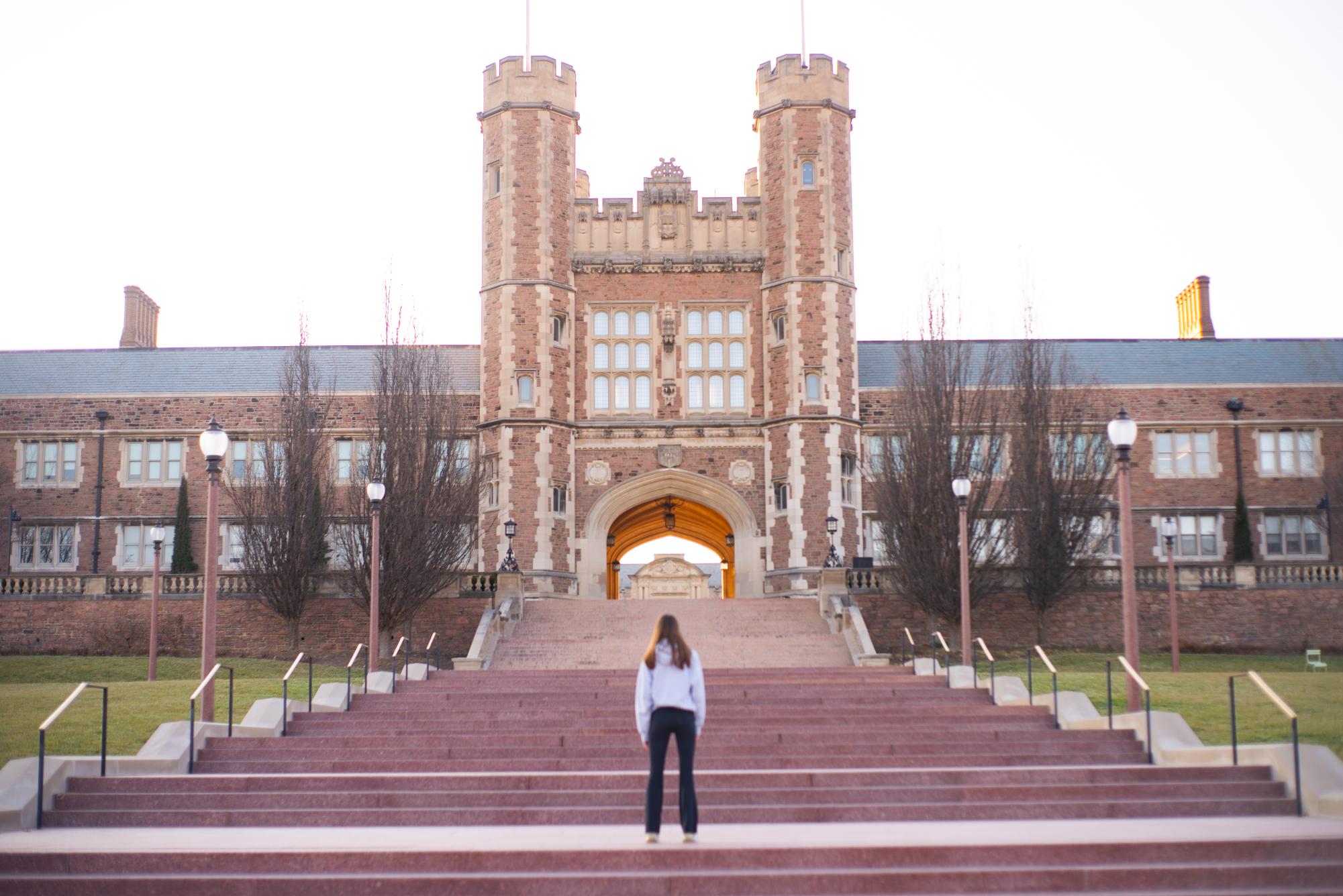 Westminster student gazes up eagerly at majestic college campus from the bottom of the grand staircase, anticipating her future.