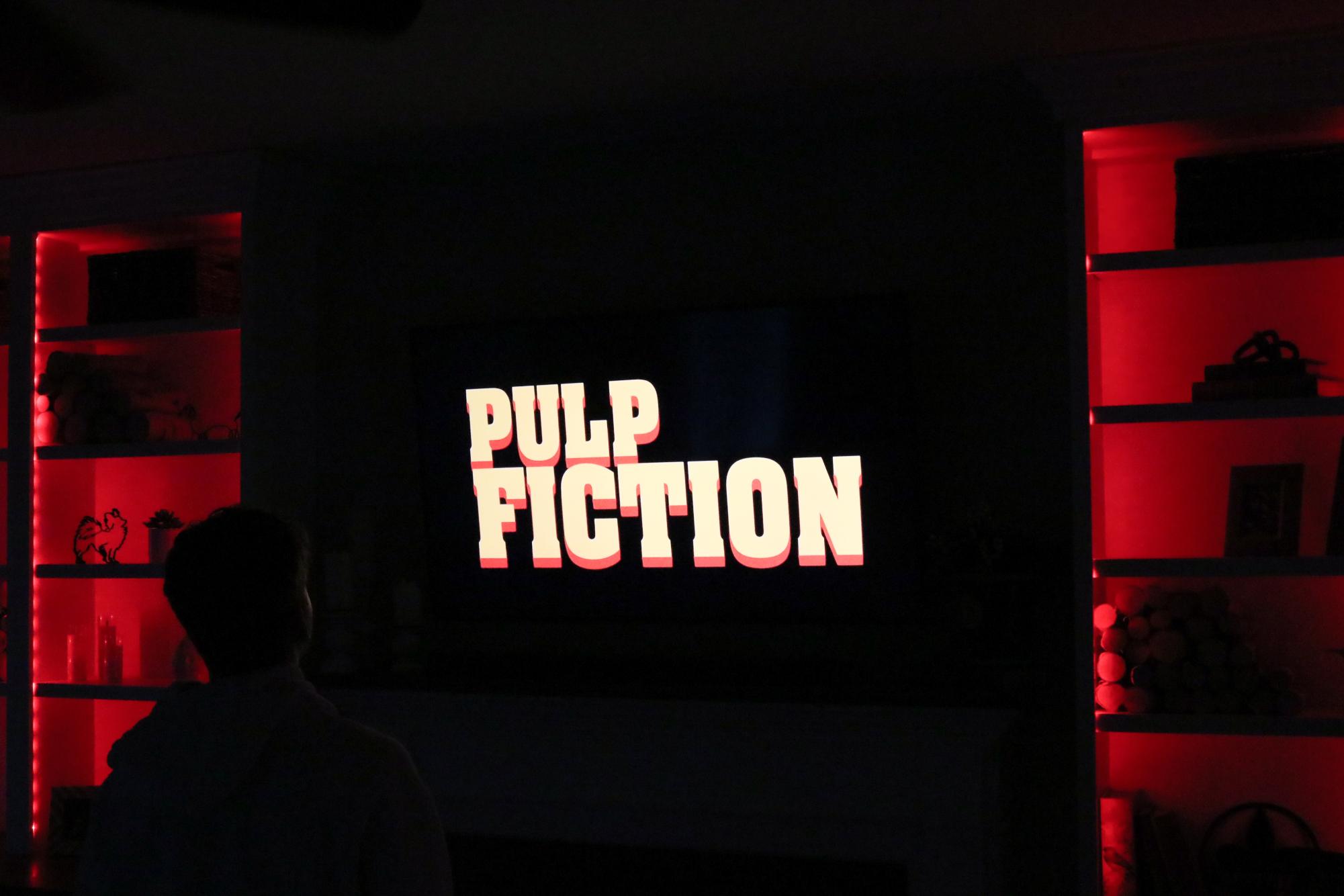 A person watches the television as the iconic film, Pulp Fiction, begins.