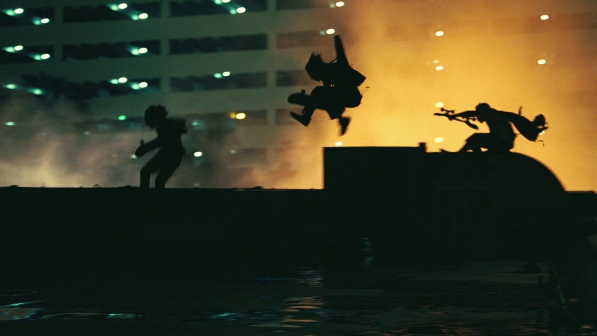 Still of three people on a rooftop from the film One Battle After Another